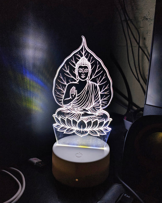 Gautam Buddha 3D LED illusion lamp by Glow X Art for elegant home decoration, ideal spiritual gift for mindfulness and peace, beautifully glowing acrylic LED lamp perfect for meditation rooms and living spaces, serene Buddha night light for calming atmosphere and office desks, thoughtful gift for yoga practitioners and spiritual seekers, artistic 3D Buddha LED lamp enhancing tranquility and wellness, Glow X Art Buddha lamp designed for home altars and special gifting occasions, intricately laser-engraved Bu