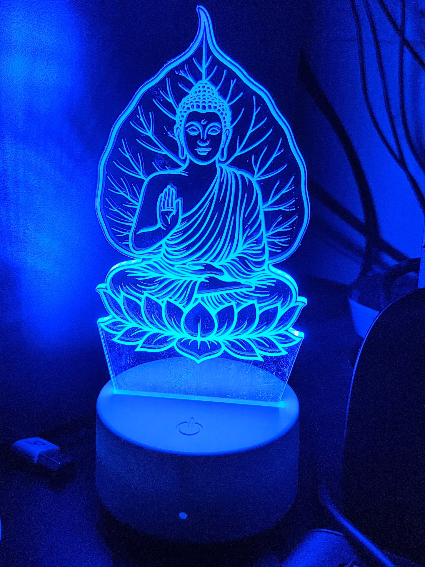 Gautam Buddha 3D LED illusion lamp by Glow X Art, perfect for spiritual home decor and meditation spaces, glowing acrylic LED lamp offering peaceful ambiance and unique gifting option, elegant Buddha night light ideal for yoga lovers and mindfulness seekers, artistic Glow X Art Buddha lamp enhancing tranquility and calm in any room, intricately designed laser-engraved Buddha LED lamp for serene home decoration and meaningful gifts, luminous 3D Buddha lamp by Glow X Art creating a relaxing atmosphere for med