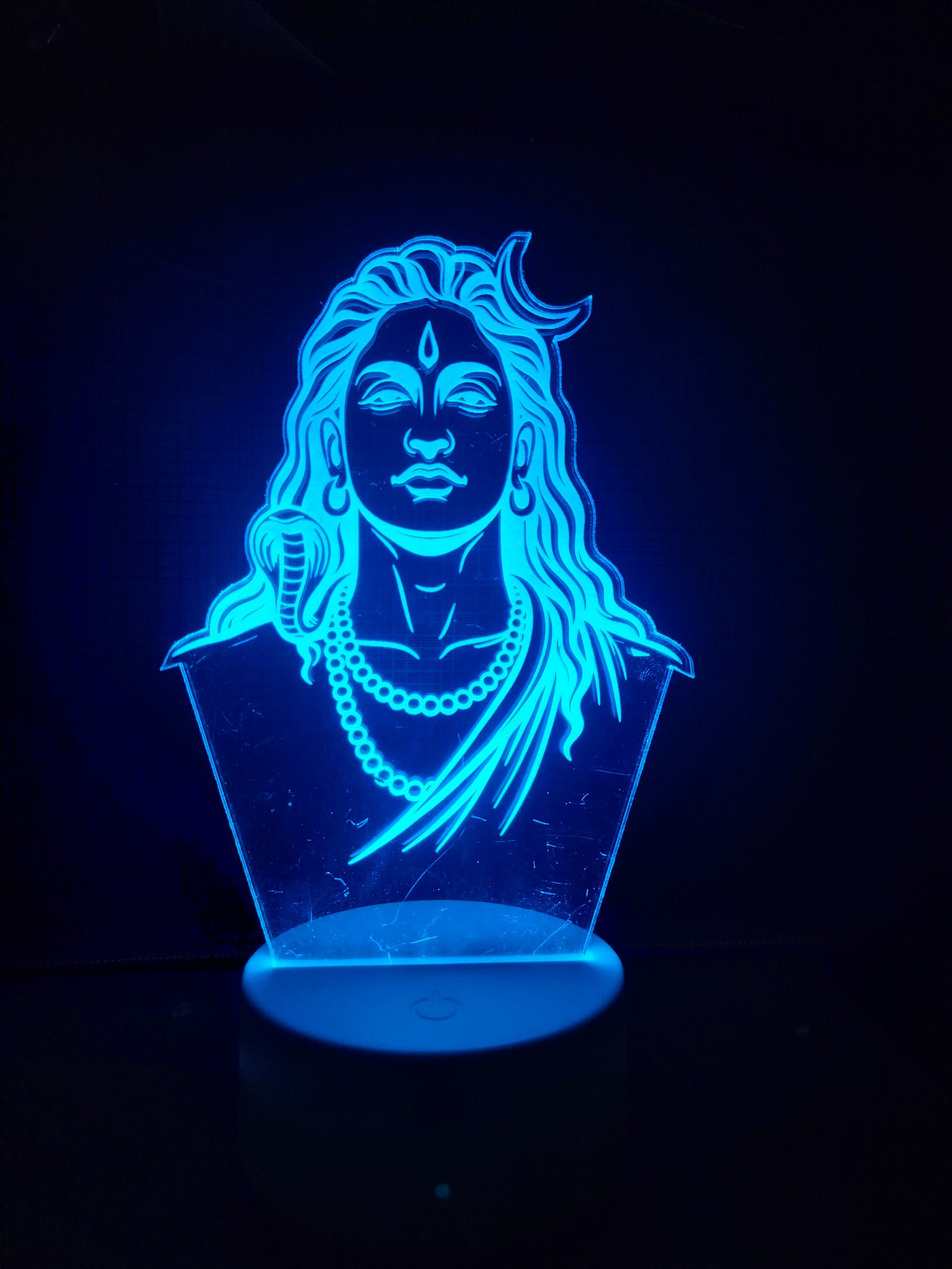 Adiyogi LED lamp displayed on wooden desk
Unlit Adiyogi 3D illusion lamp in daylight
Acrylic Adiyogi lamp without light
Adiyogi night light on natural wooden surface