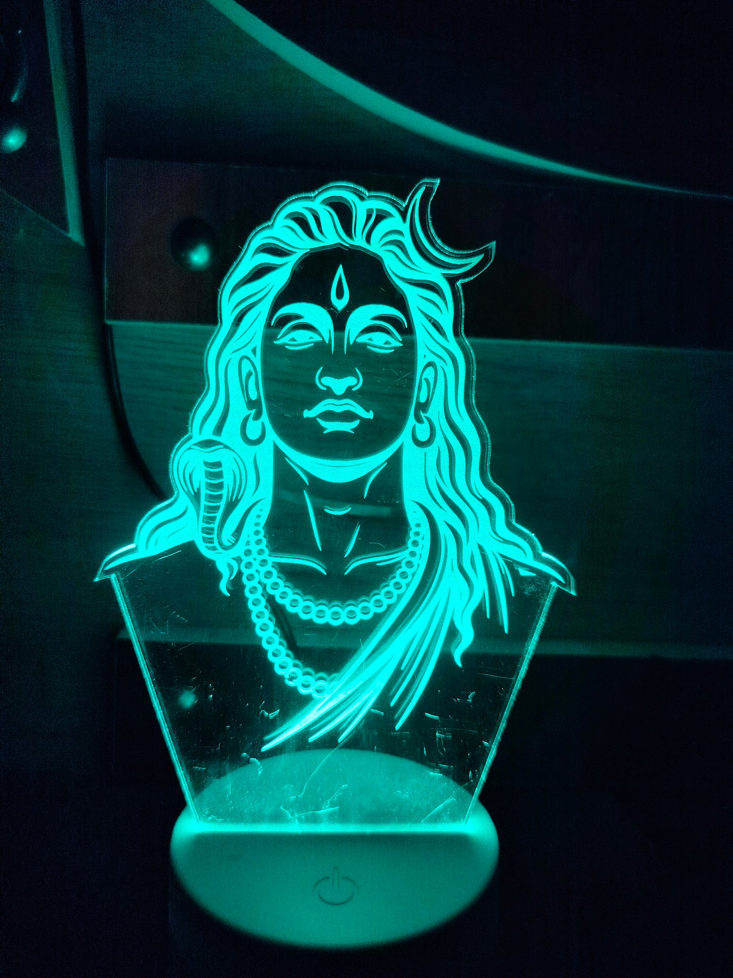 Wooden LED base of Adiyogi illusion lamp
Touch-sensitive LED lamp base close-up
Adiyogi 3D lamp power base detail
Round wooden stand for Adiyogi night lamp