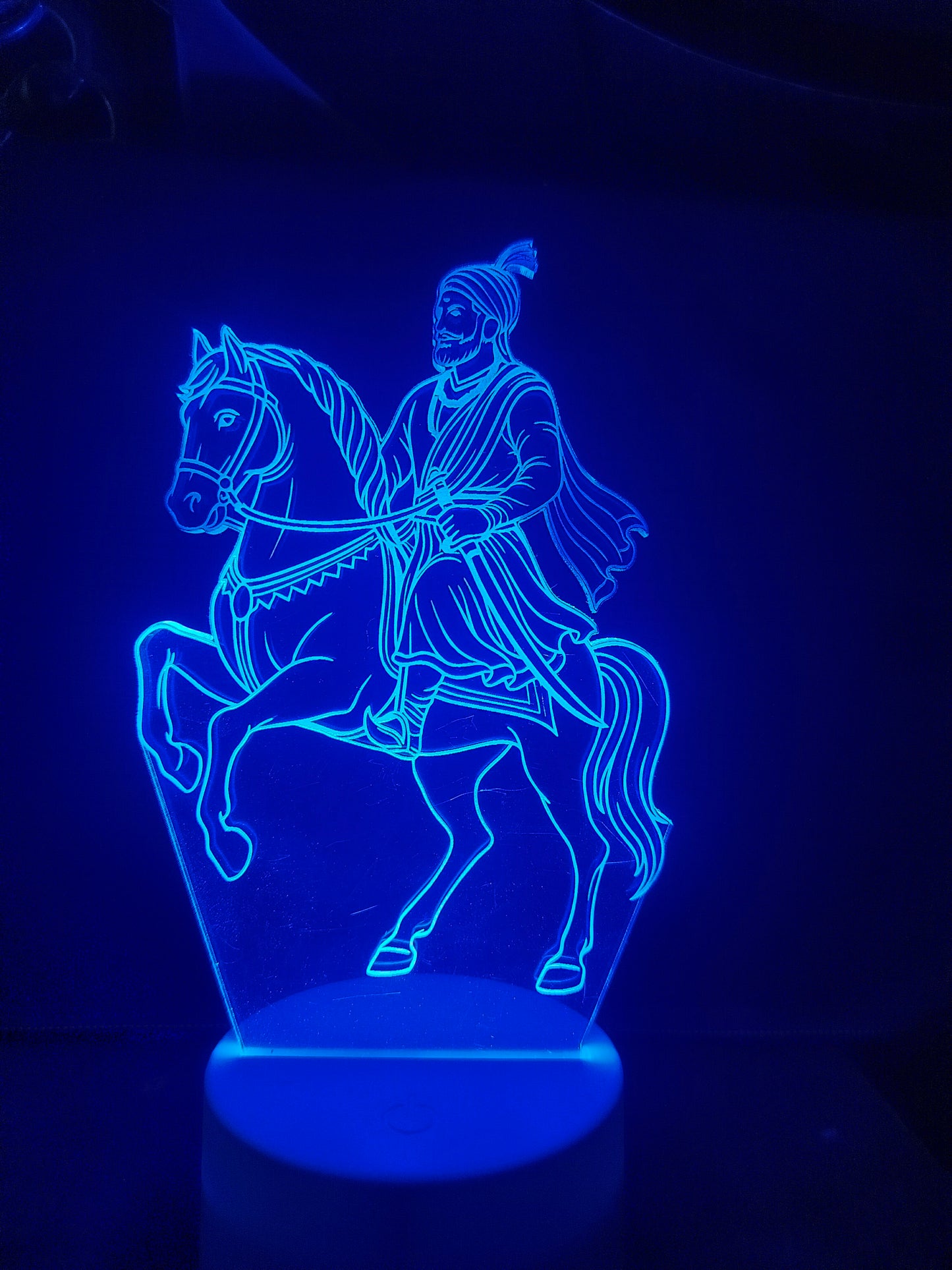 Shivaji Maharaj LED lamp glowing in red light
Color-changing Shivaji 3D illusion light
Blue glow of Shivaji Maharaj acrylic lamp
Multicolor lighting of warrior lamp