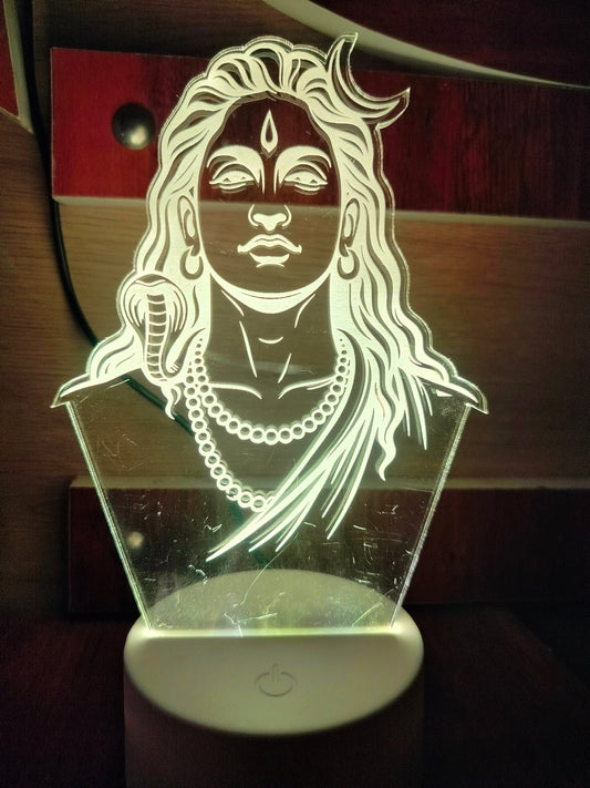 Adiyogi LED lamp displayed on wooden desk
Unlit Adiyogi 3D illusion lamp in daylight
Acrylic Adiyogi lamp without light
Adiyogi night light on natural wooden surface

