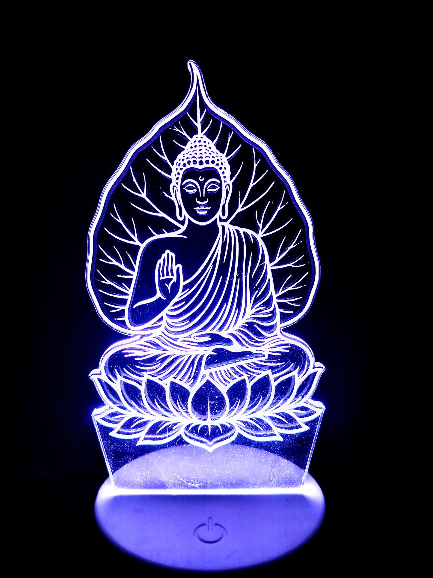 Side view of acrylic Buddha lamp under peepal tree

Meditating Buddha 3D LED light viewed from angle

Tree and Buddha pose from side in illusion lamp

Spiritual LED lamp of Buddha and sacred tree from side