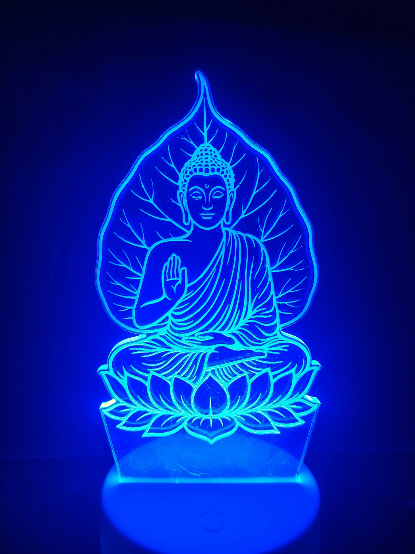 Detailed engraving of Buddha face and peepal tree

Close-up of Bodhi tree leaves and Buddha in lamp

3D etched portrait lamp showing fine detail

Peaceful Buddha face and tree branches close view

