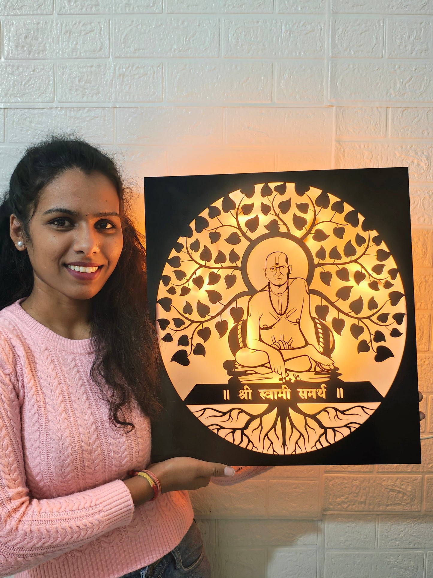 Woman holding a decorative wall art piece with a shree swami samarth  figure and tree design.
Swami Samarth spiritual lighting décor for home
Acrylic black laser cut LED spiritual wall frame
Swami Samarth pooja room backlit wall art